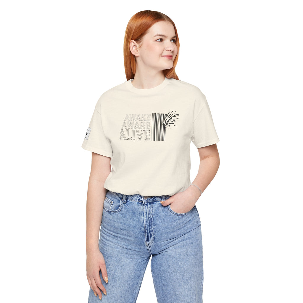 Woman wearing natural color t-shirt with “Awake Aware Alive” text design, minimalist graphic with barcode element, modern aesthetic