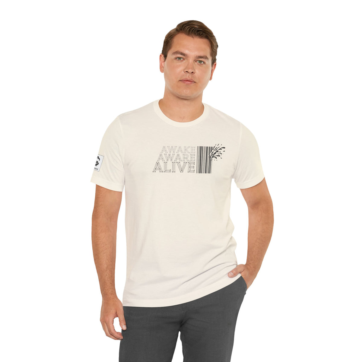 Man wearing natural color t-shirt with “Awake Aware Alive” text design, minimalist graphic with barcode element, modern aesthetic